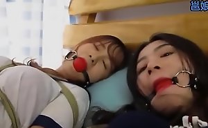 Bound and gagged asian sluts get teased by a dyke