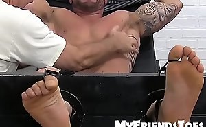 Huge muscular dude endures a feet tickling torment